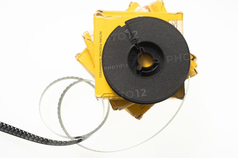 Studio shot of 8 mm film reel spool and boxes