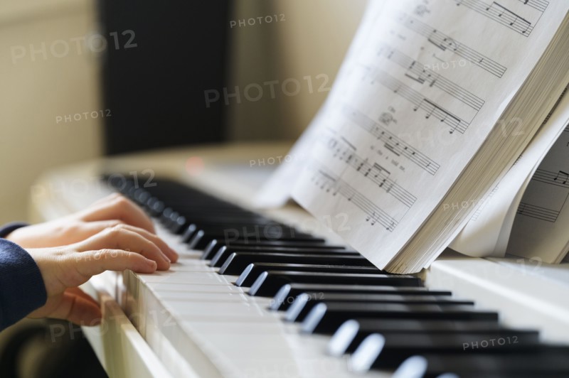 Hands of boy (6-7) playing piano
