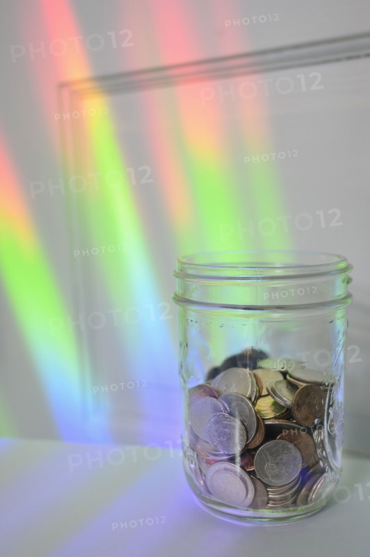 Jar of coins with rainbow light