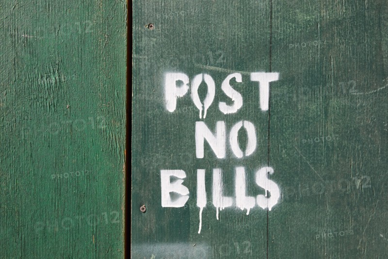 Post no bills on green wooden fence