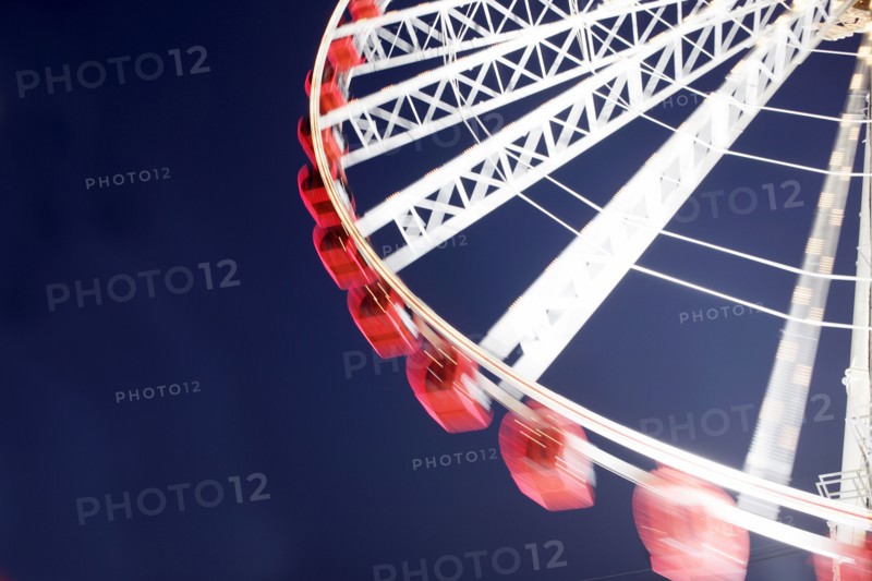 Low angle view of spinning ferris wheel