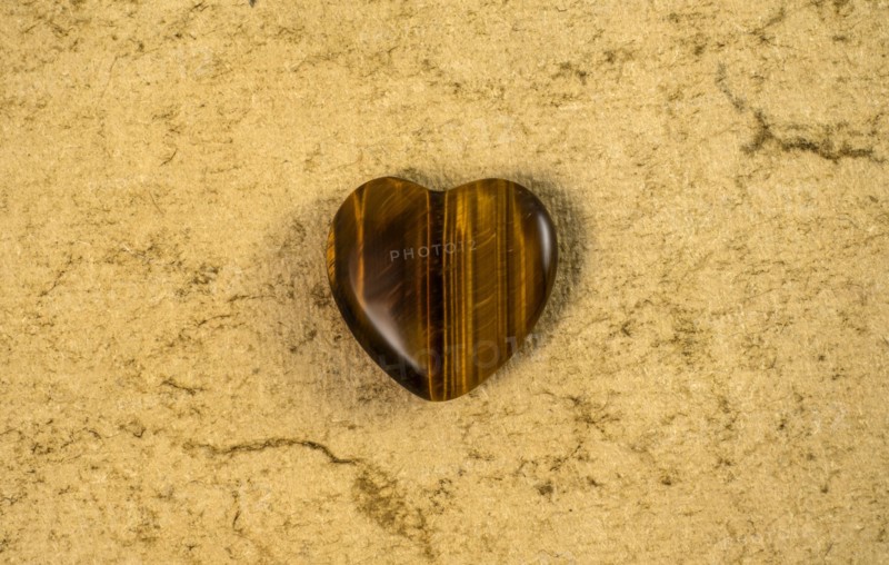 Wooden heart on beige background