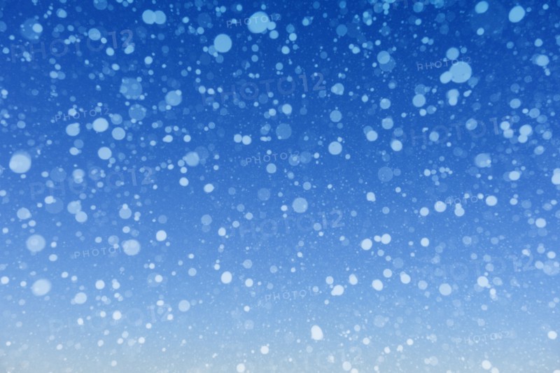 Falling snow against blue background