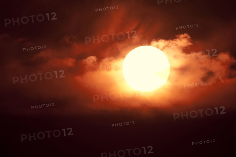 Setting sun among clouds