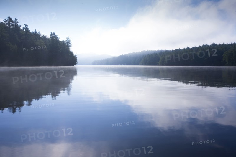 Usa, New York State, Morning fog on Upper Saranac Lake