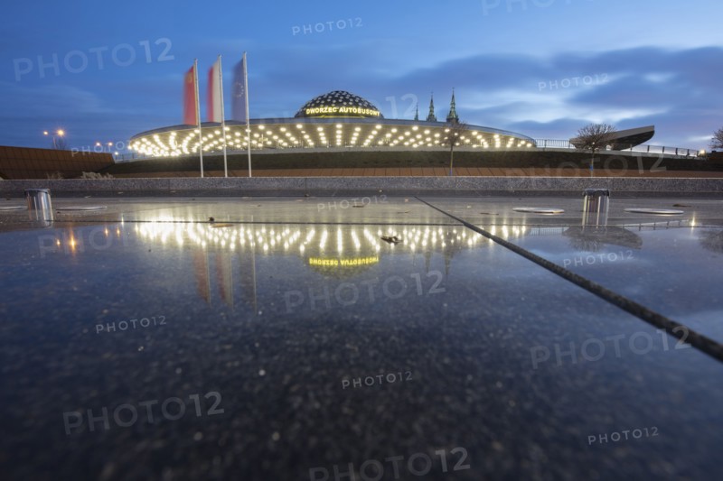 Poland, Holy Cross, Kielce, Bus station reflecting in puddle