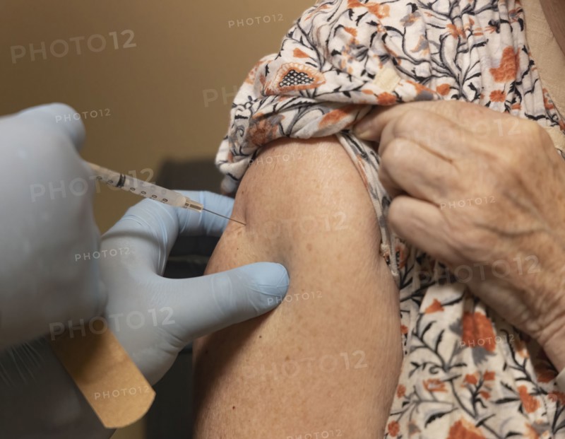 Close-up of senior woman receiving dose of Covid-19 vaccine
