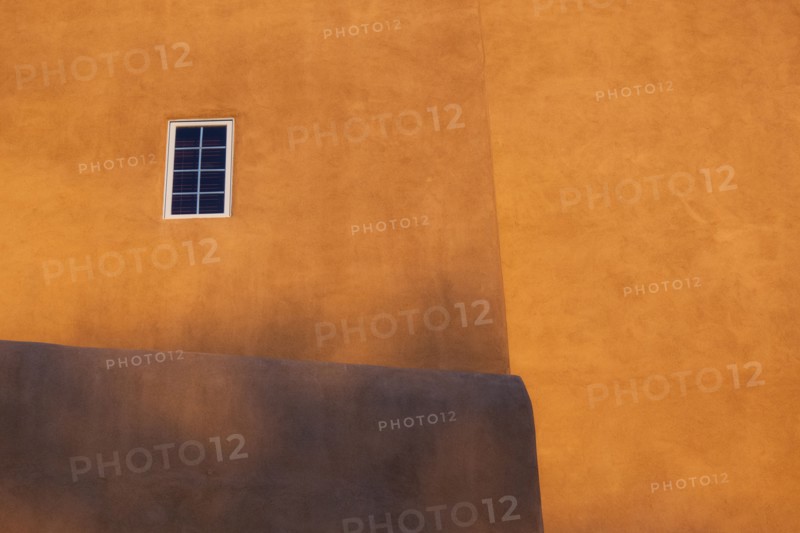 Usa, New Mexico, Santa Fe, Yellow walls of Adobe style house with window