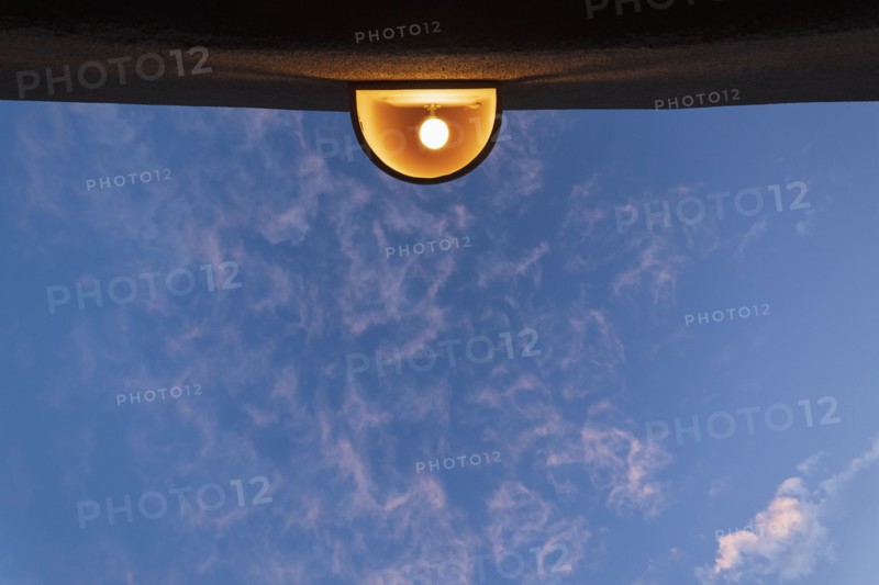 Low angle view of outdoor lamp on building against blue sky