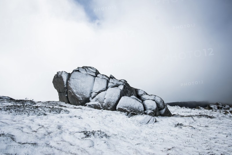 Australia, New South Wales, Snowcapped rock in mountains at Charlotte Pass in Kosciuszko National Park