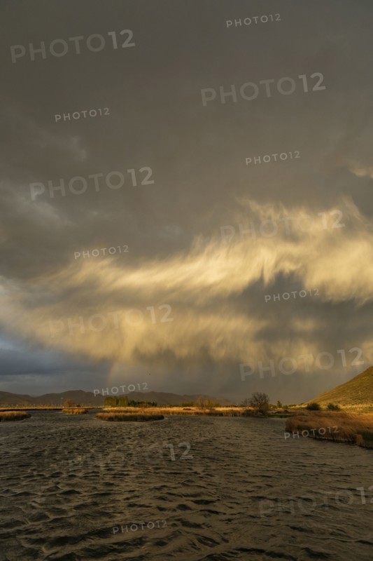 Usa, Idaho, Picabo, Storm clouds over landscape at sunset
