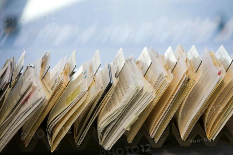 Close-up of files stacked on desk in office