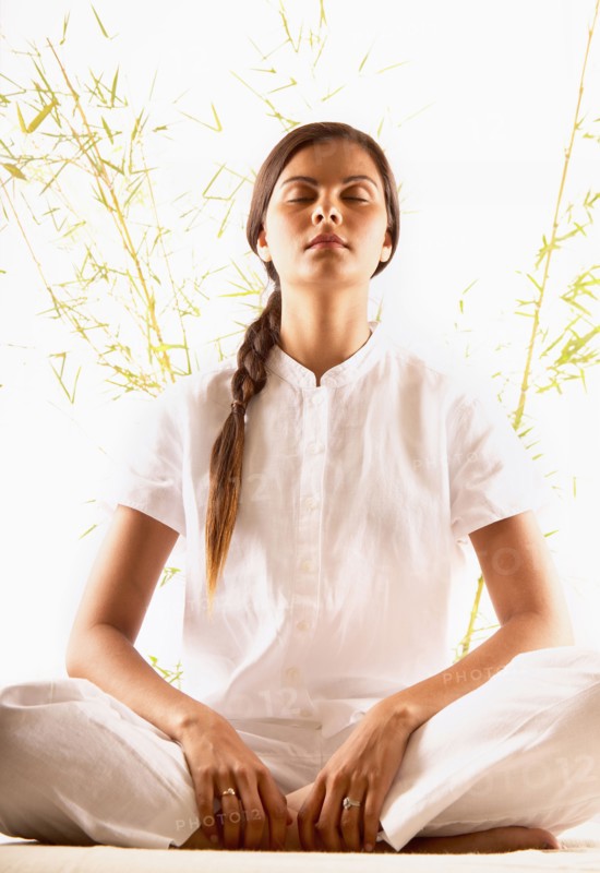 Woman meditating with eyes closed
