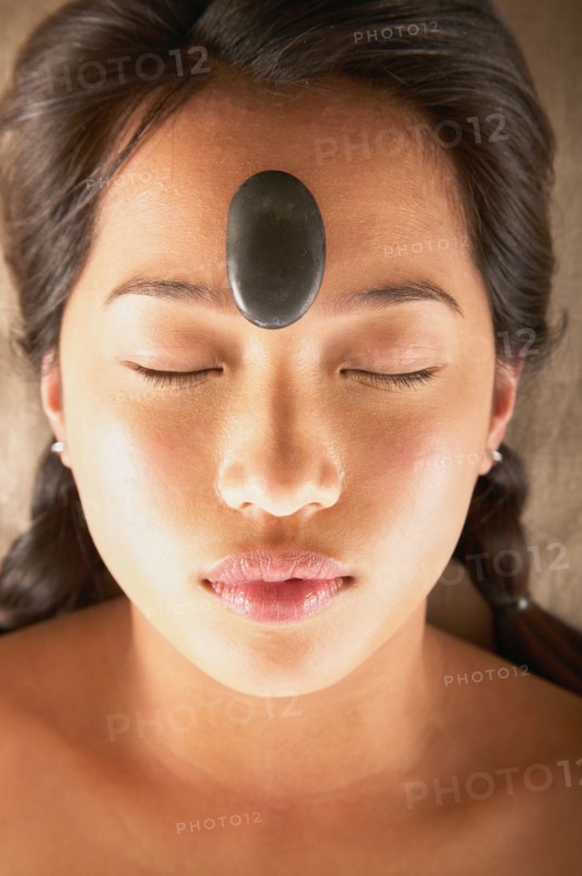 Woman with rock on forehead