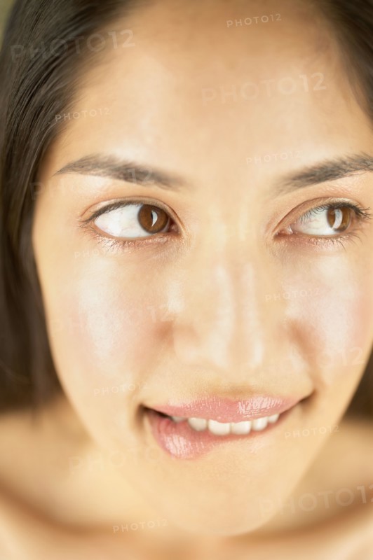Close-up of woman biting lips