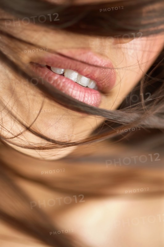Close-up of woman's lips and brown hair