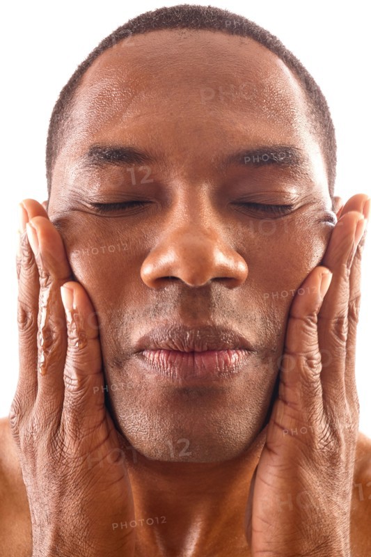 Close-up of man rubbing face
