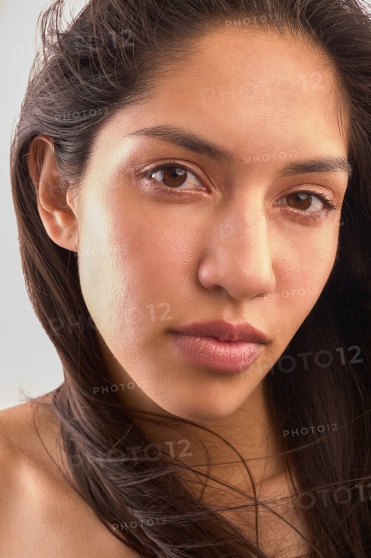Studio portrait of woman with brown hair