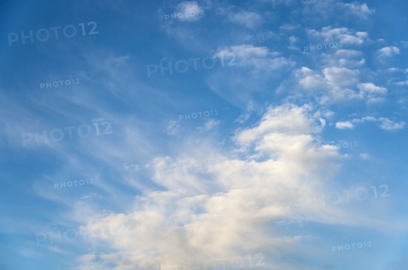 Blue sky with soft puffy clouds