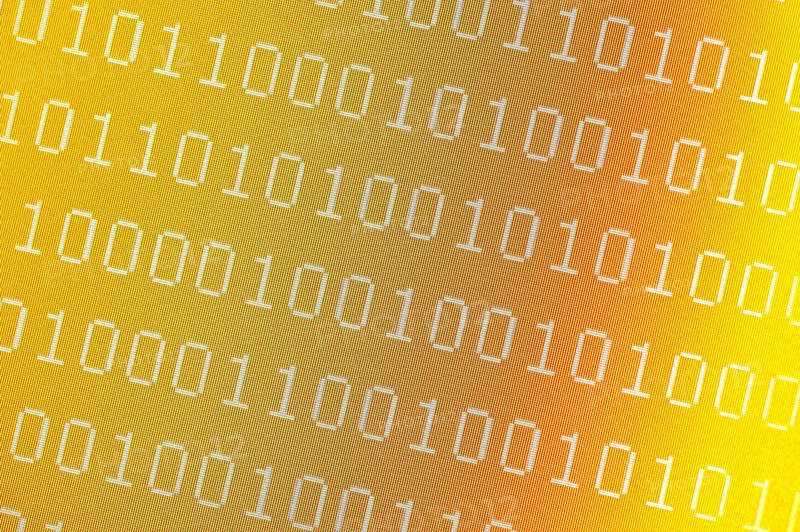 Binary numbers on pixelated yellow computer screen