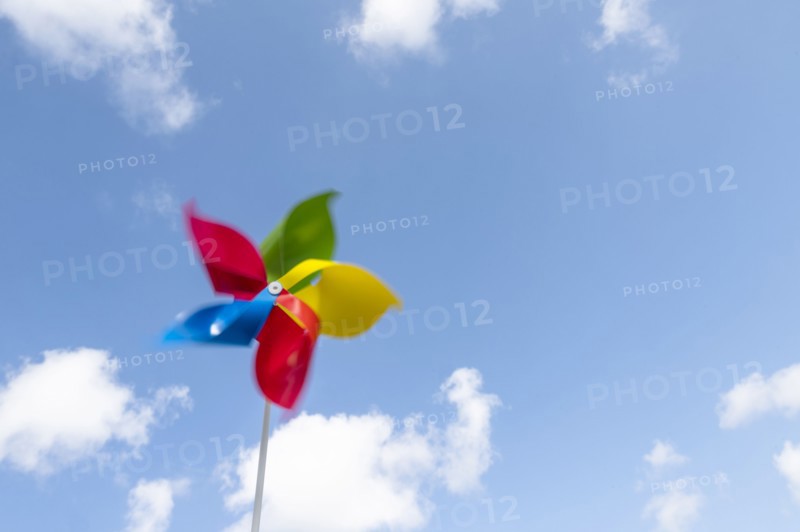 Colorful pinwheel blowing in wind against sky