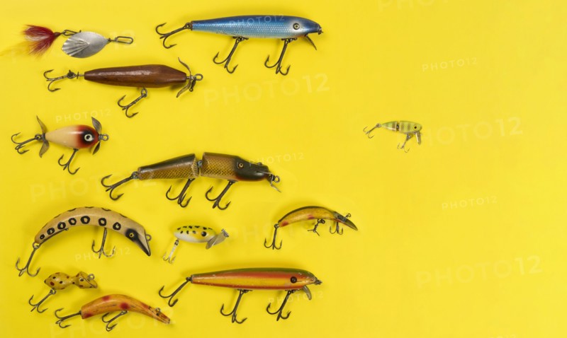 Retro fishing lures against yellow background