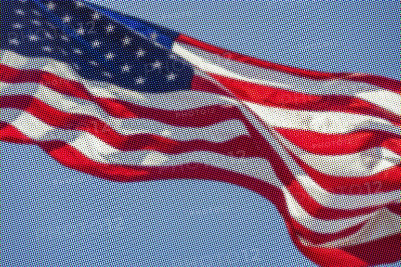 Pixelated American flag waving against sky