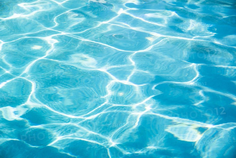 Surface of blue rippled water reflecting sunlight