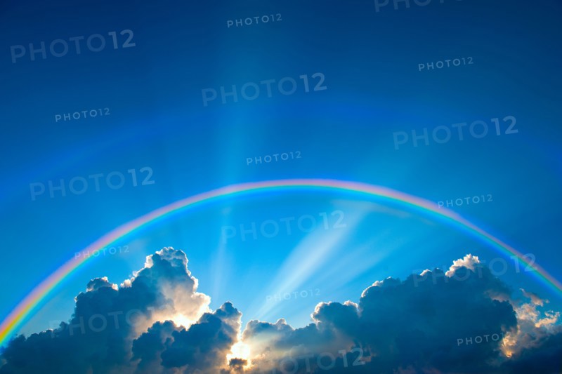 Double rainbow and clouds on sky at sunset