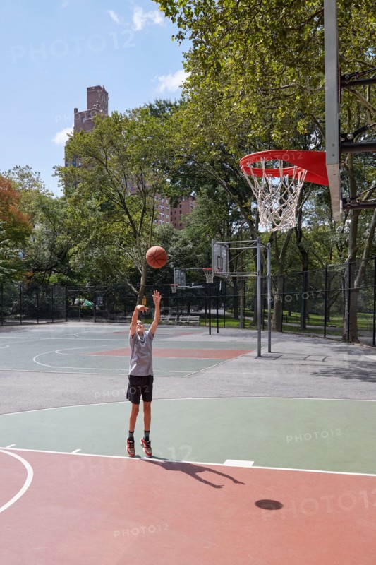 Boy playing basketball in park