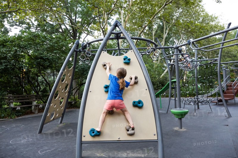 Rear view of girl on climbing wall