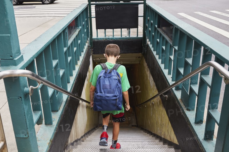 Rear view of boy with backpack