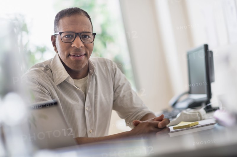 Portrait of smiling mature man working in home office