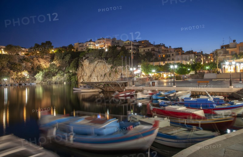 Boats in harbor and village on cliffs