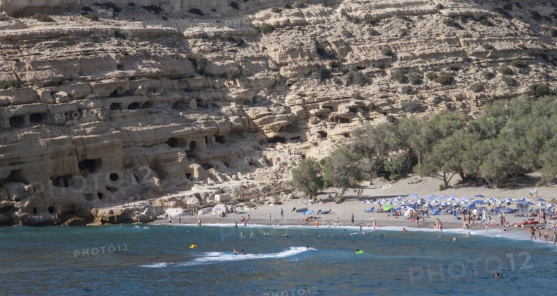 Tourists lying on beach and bathing in sea