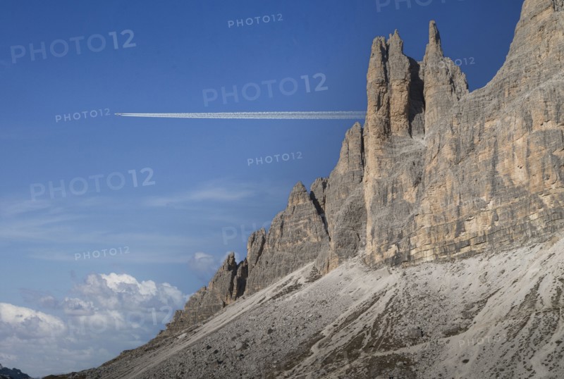Commercial jet flying over Dolomites