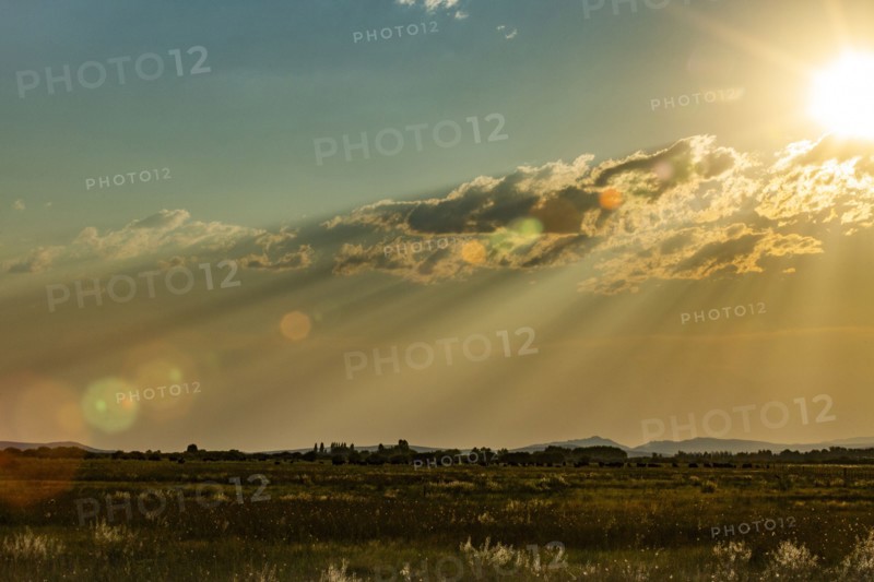 Late sun creating god rays over rural landscape