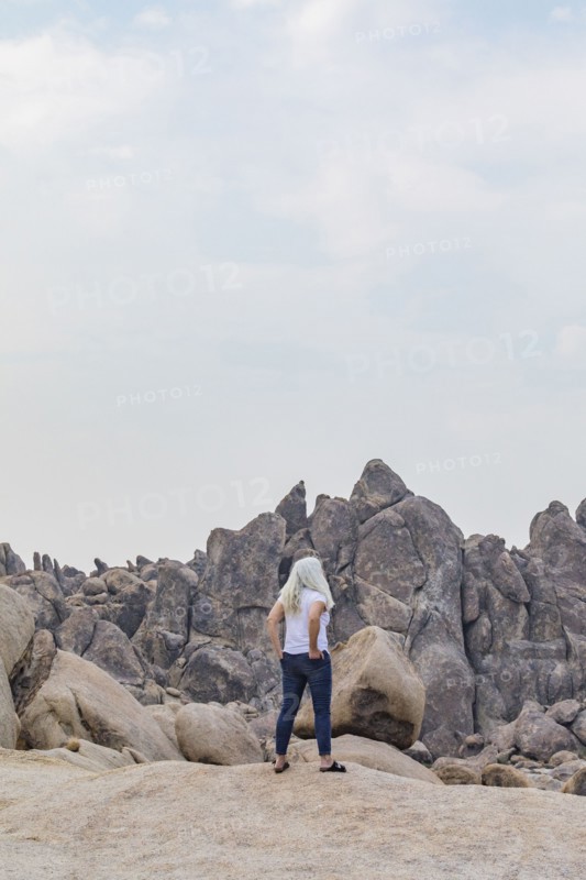Woman looking at Alabama Hills rock formations