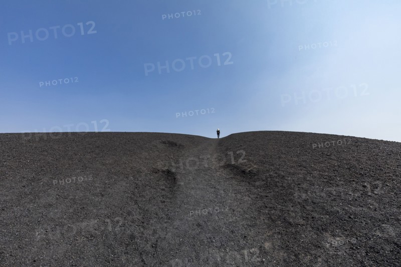 Woman hiking in cinder cone at Craters of the Moon National Monument