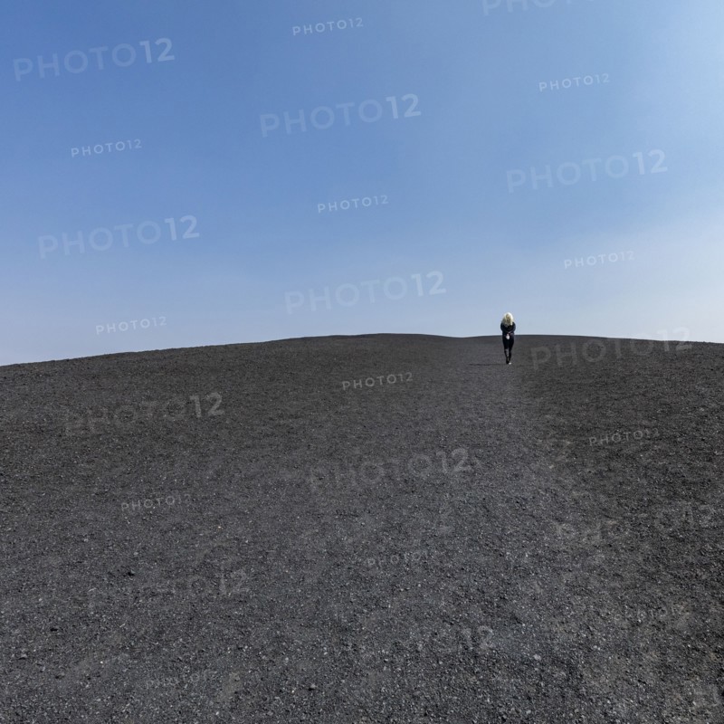 Woman hiking in cinder cone at Craters of the Moon National Monument