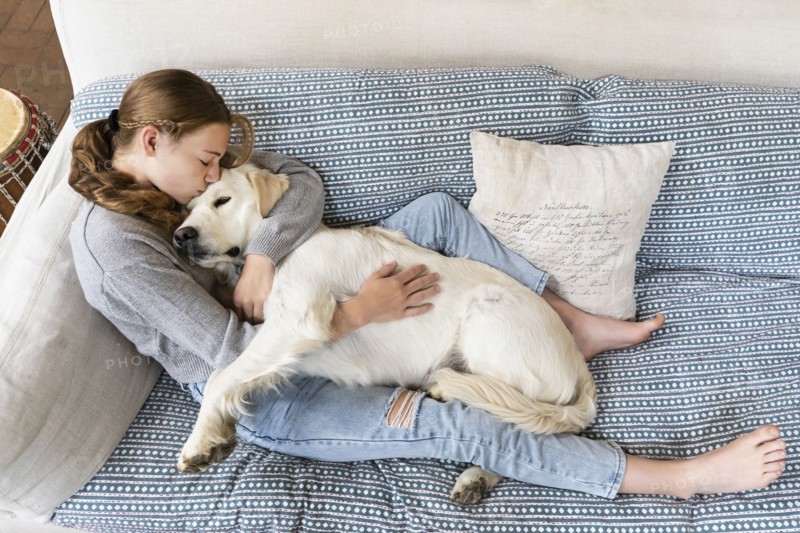 Girl embracing English Cream Golden Retriever