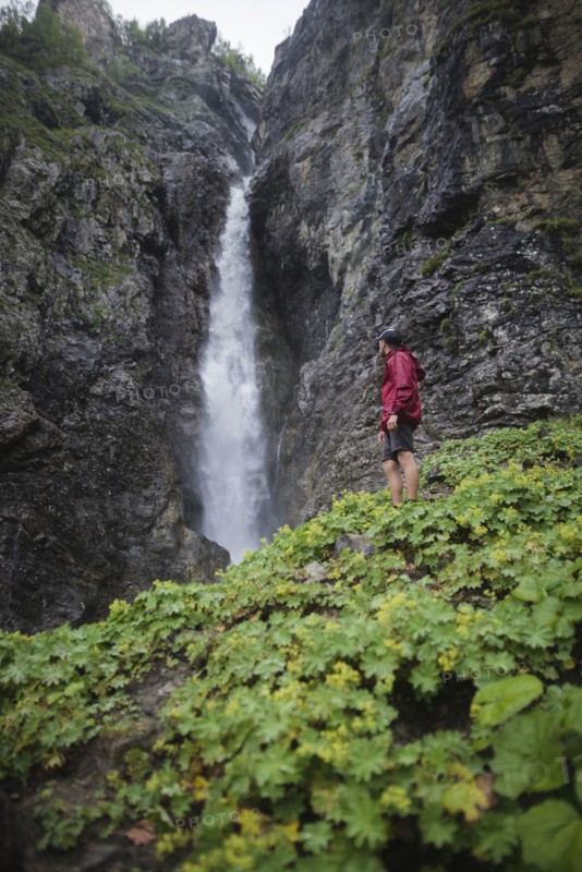 Hiker standing near waterfall