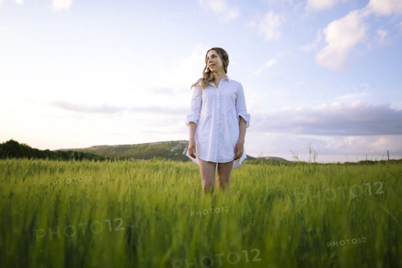 Young woman standing in agricultural field