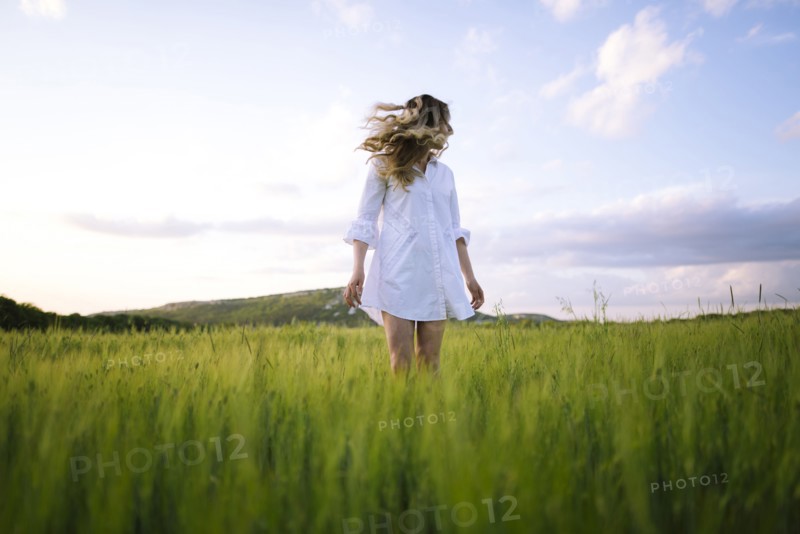 Young woman standing in agricultural field