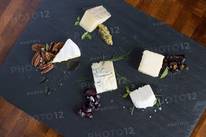 Cheese and herbs on cutting board