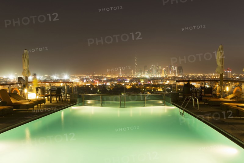 Swimming pool over cityscape at night