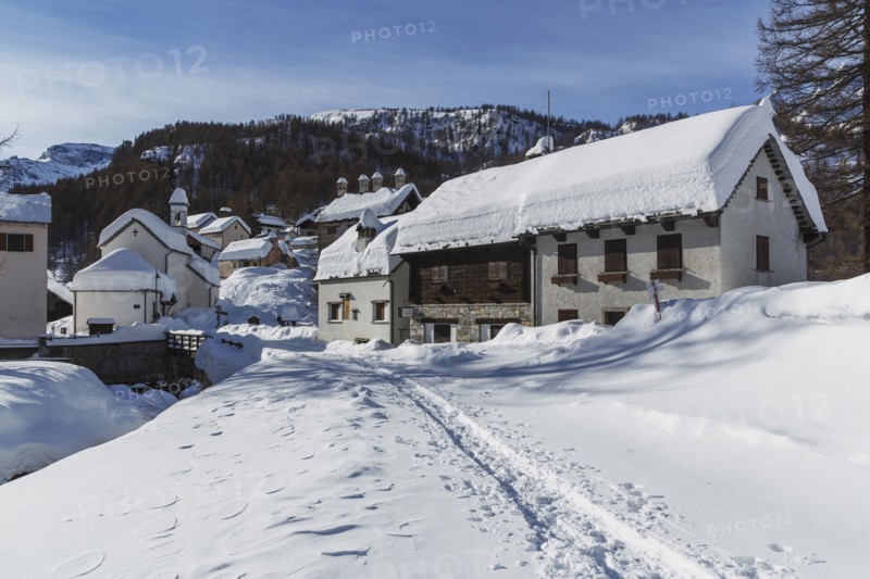 Path through snow to rural mountain village