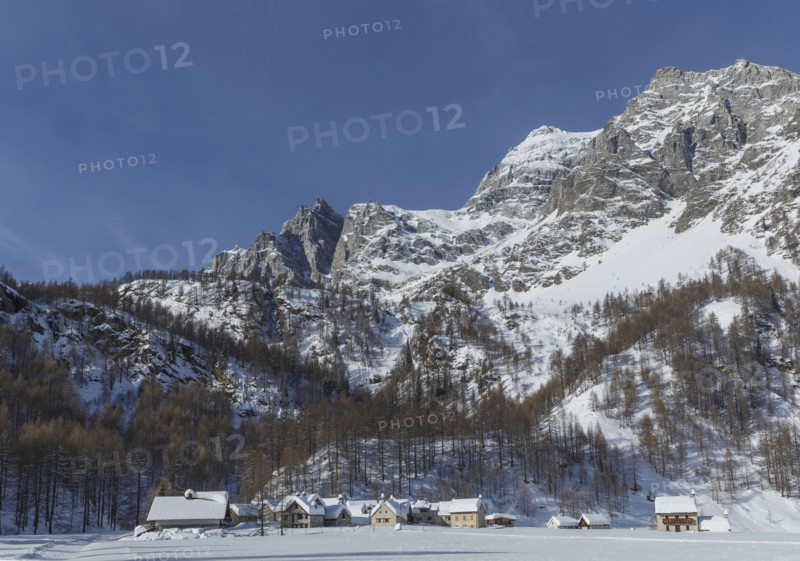Rural village under snowy mountains