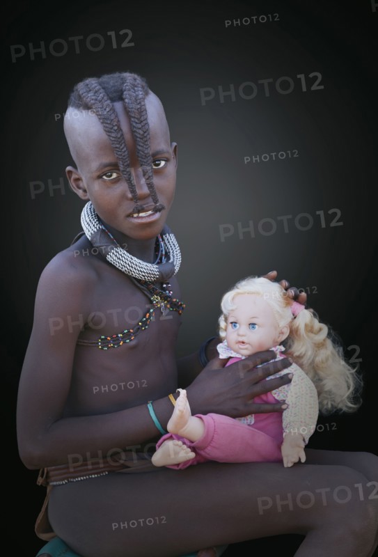 Black girl playing with baby doll