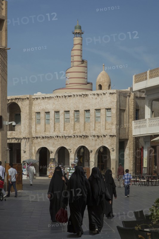 Women in hijab walking in Doha square